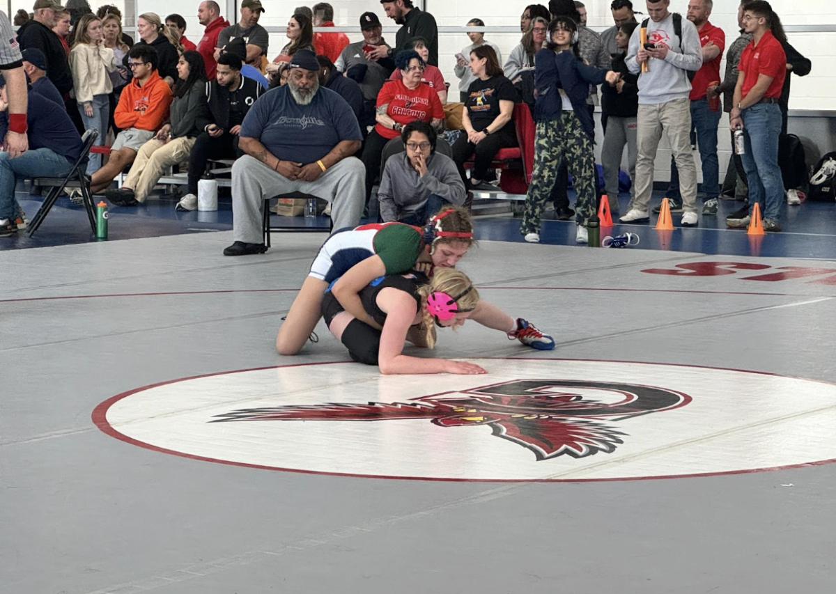 Two girl wrestlers are up against each other, with sophomore Jayelle Jones from Jefferson positioned atop her opponent. “It was a great experience. [It was] really difficult but I absolutely recommend it to girls especially. We can wrestle boys and we can fight. Dont let anyone tell you otherwise,” senior Harika Akundi said. 